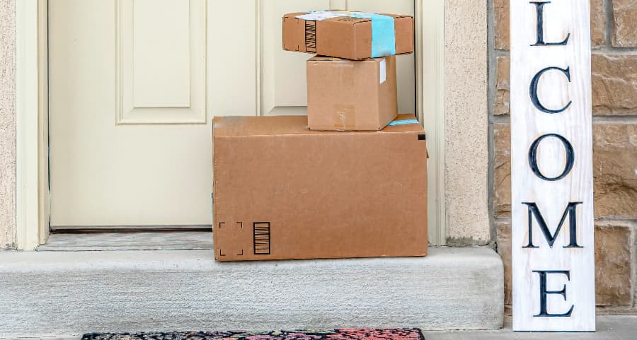 Deliveries on the front porch of a house with a welcome sign in Oceanside